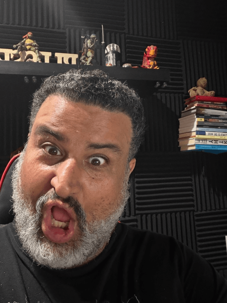 Giuseppe mid-performance with an expressive shocked face in the studio